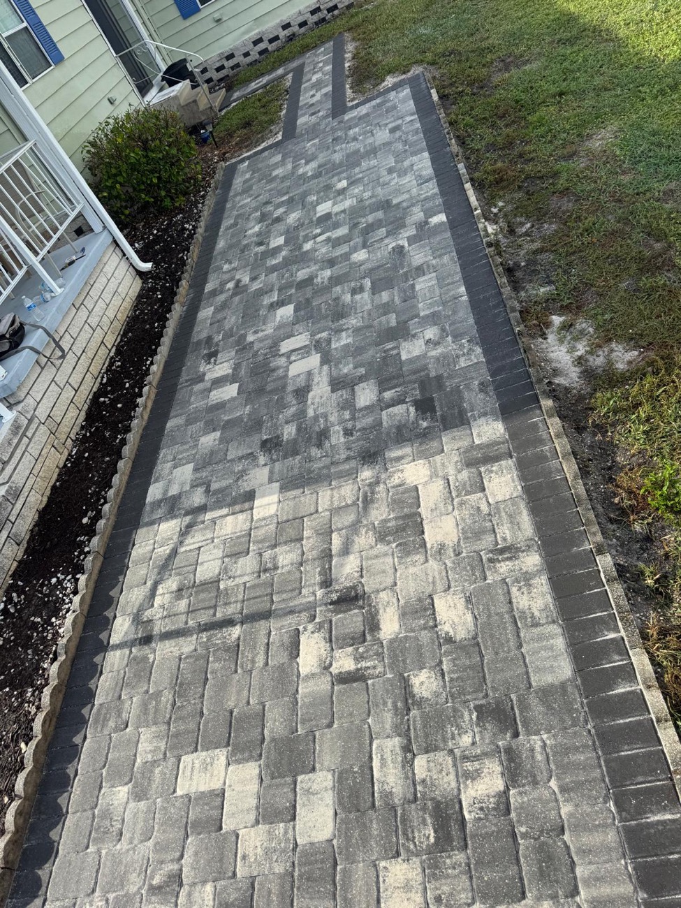Herringbone paver walkway with a charcoal border