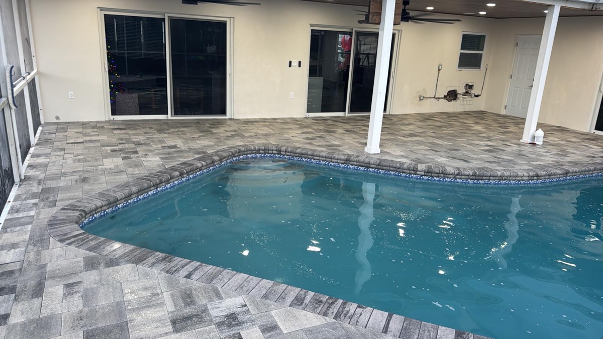 Covered patio and pool deck in charcoal pavers