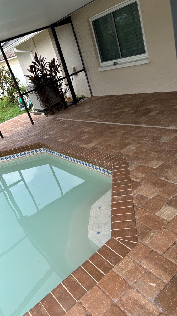 Pool with a brick paver deck